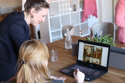 Two women working on a laptop